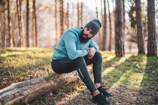 Exhausted man after exercise sitting in the nature photo