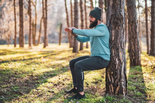 Man looking at his watch while exercising in nature photo