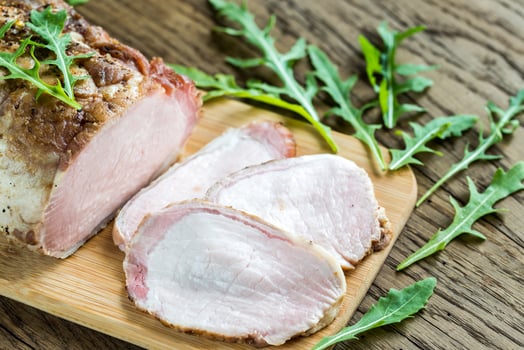 Baked meat with fresh rocket salad on the wooden board photo