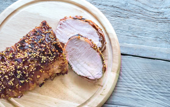Baked pork meat wrapped in bacon photo