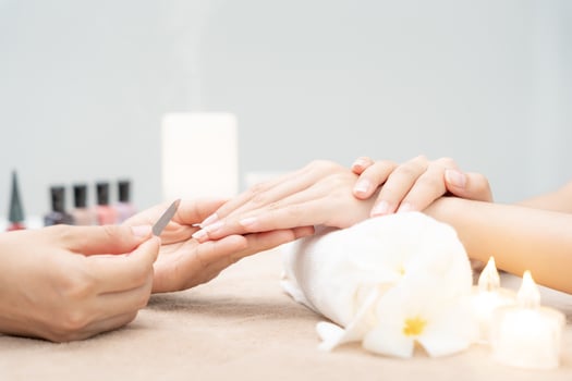 Woman receive care service by professional Beautician Manicure at spa centre. Nail beauty salon use nail file for Glazing treatment. manicurist make nail customer to beautiful. body care spa treatment photo