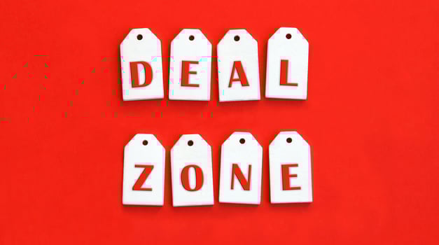 Eight white wooden tags with the word DEAL ZONE. photo