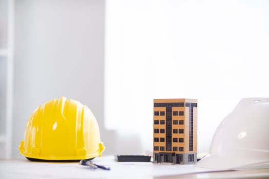Yellow safety helmet were prepared for workers to wear before entering the construction area to prevent the danger of falling objects from working. Yellow safety helmet is placed on a wooden table. photo