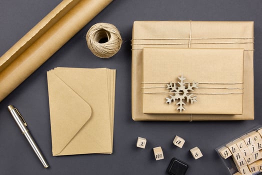 Christmas envelope mockup with handmade gift boxes and decoration on dark background. Festive styled composition. Top view. Copy space. photo