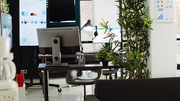 Empty small business open space with desk supplies and company workstations, modern urban building. Startup coworking space used for marketing and research work, boardroom office. photo