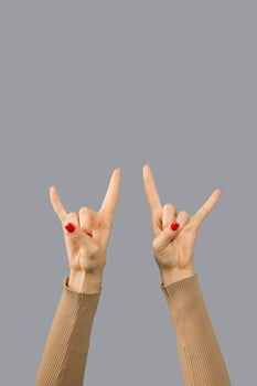Signs of horns from two female hands isolated. photo