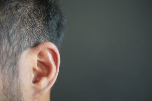 closeup of human ear on black background photo