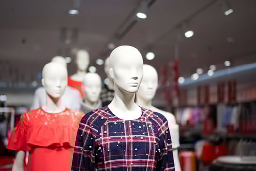 Female mannequins are dressed in casual clothes with a red-orange theme in fashion shop at the department store. photo