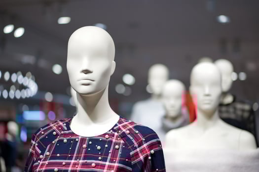 Female mannequins are dressed in casual clothes with a red-orange theme in fashion shop at the department store. photo