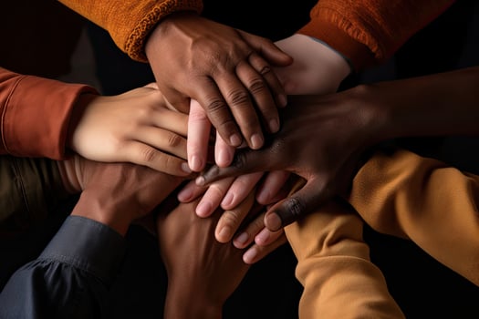 Group of diverse people holding hands together on black background, closeup, Stack of hands showing unity and teamwork, AI Generated photo
