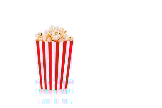 Glass with popcorn on a white background photo