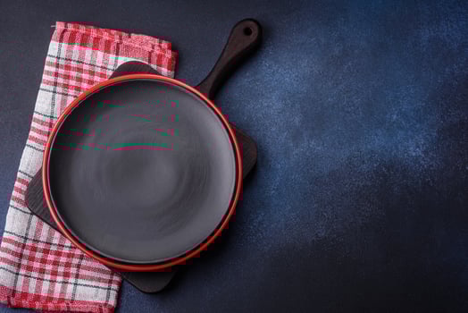 Round empty colored ceramic plate on concrete texture background photo