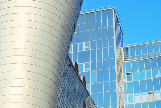 Structural glass wall reflecting blue sky. Abstract modern architecture fragment photo