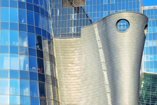Structural glass wall reflecting blue sky. Abstract modern architecture fragment photo