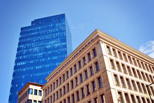 Structural glass wall reflecting blue sky. Abstract modern architecture fragment. photo