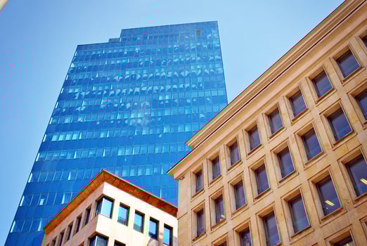 Structural glass wall reflecting blue sky. Abstract modern architecture fragment photo