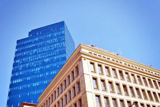 Structural glass wall reflecting blue sky. Abstract modern architecture fragment photo