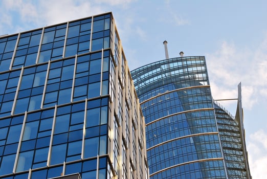 Structural glass wall reflecting blue sky. Abstract modern architecture fragment. photo