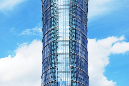 Structural glass wall reflecting blue sky. Abstract modern architecture fragment photo