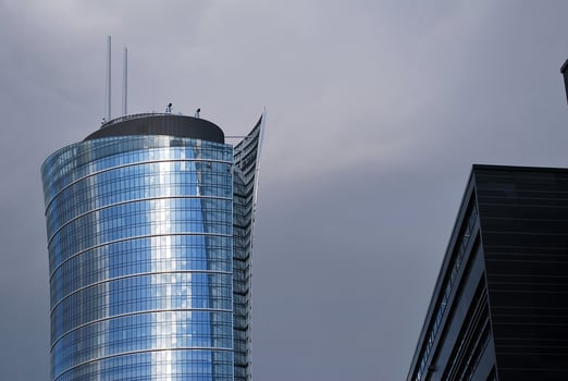 Structural glass wall reflecting blue sky. Abstract modern architecture fragment. photo