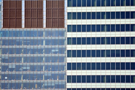 Structural glass wall reflecting blue sky. Abstract modern architecture fragment. photo