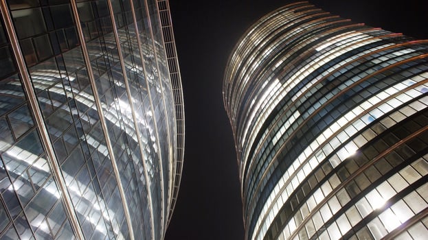 Pattern of office buildings windows illuminated at night. Glass architecture ,corporate building at night - business concept. photo
