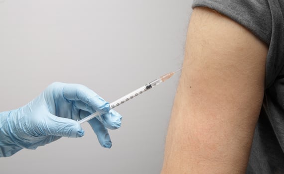 the hand of a paramedic makes an injection of insulin to an invisible person. health and nutrition concept. diabetes. High quality photo