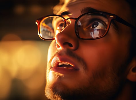 AI generated A young man looks up through his glasses. AI generated. photo