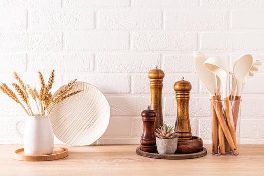 A set of beautiful wooden eco-friendly kitchen utensils on a wooden countertop in a modern bright space. A zero-waste kitchen. Front view. photo