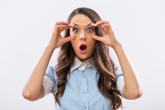Image of businesswoman with big blue eyes staring on gray background photo