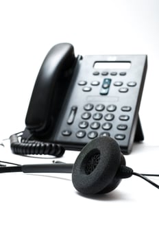 Black desktop phone with a headset on the white background photo