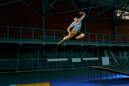 The man performs a trick. Jump. Indoor training photo