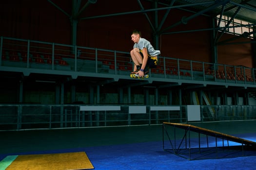 The man performs a trick. Jump. Indoor training photo