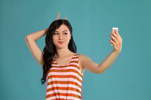 Studio photo of a gorgeous girl teenager posing over a blue background.