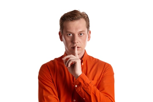 Close-up portrait of a ginger guy in orange shirt posing isolated on white background. Sincere emotions. photo