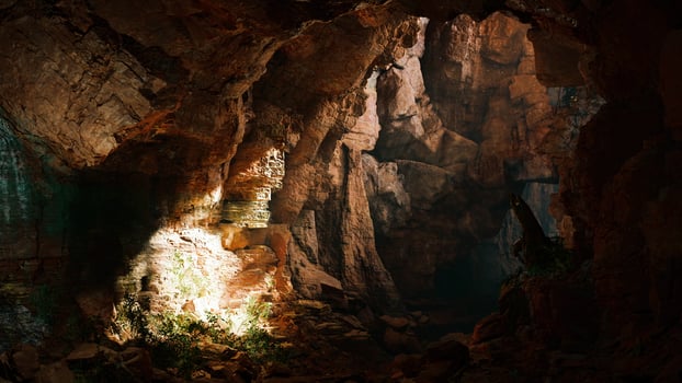 A mysterious cave illuminated by a beam of light photo