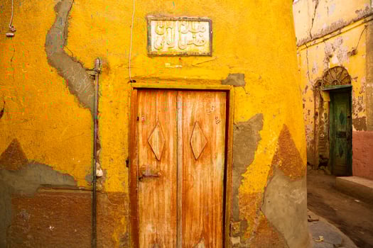 Colourful exterior wall of a Nubian house in Egypt. Typical African village houses facade. Medieval street. photo