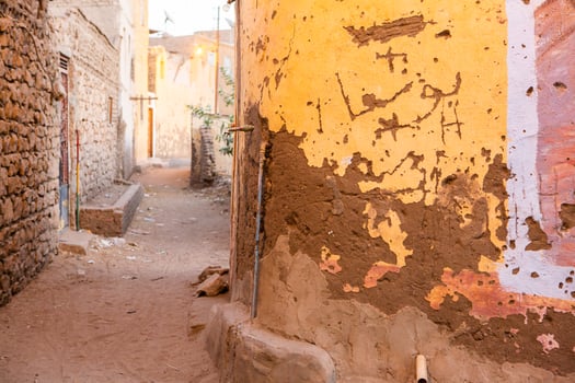 Colourful exterior wall of a Nubian house in Egypt. Typical African village houses facade. Medieval street. photo