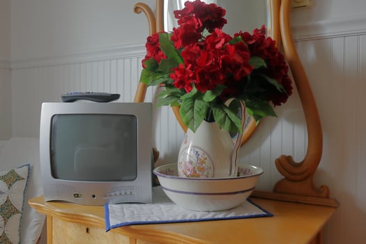 Bed and Breakfast TV and Flowers on Bureau photo