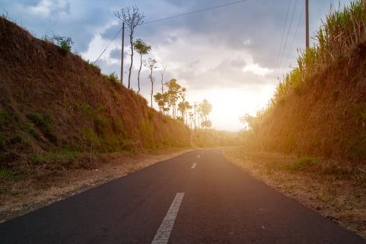 The road goes straight uphill between two cliffs photo