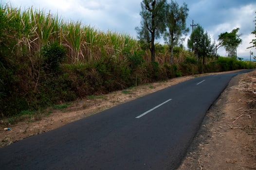 The road goes straight uphill between two cliffs photo