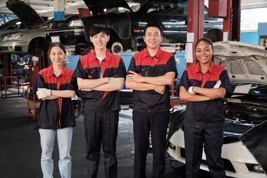 Portrait of multiracial professional mechanic team arms crossed and look at camera, work at car service garage, happy maintenance jobs, check and repair occupation in automotive industry business. photo