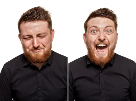 Studio portrait of a young man crying and laughing man photo