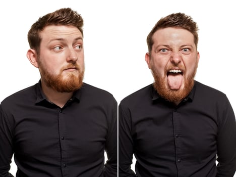 Brutal, attractive, bearded man poses in a black shirt, isolated on a white background photo