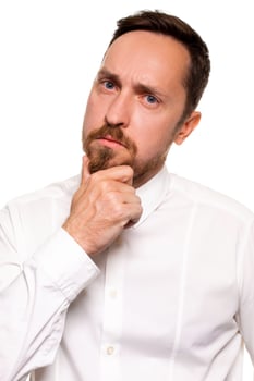 Handsome bearded man in a white shirt poses, isolated on a white background photo