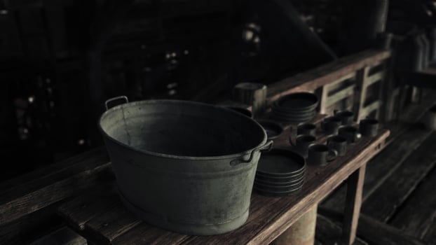 A metal bucket on a wooden table photo