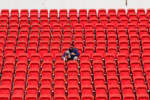 Disabled athletes in a blue shirt sitting on the red seats at the stadium, Prepare for running training. photo
