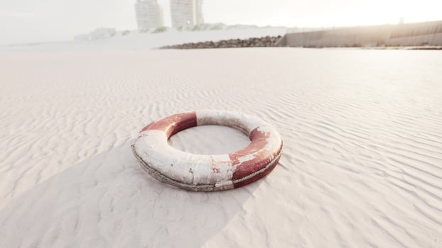 Lifebuoy on the city beach at sunset photo