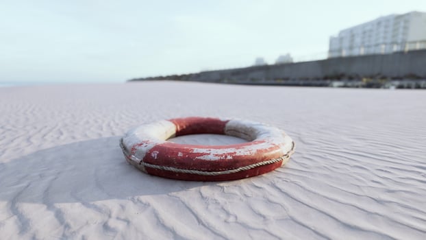 Lifebuoy on the city beach at sunset photo