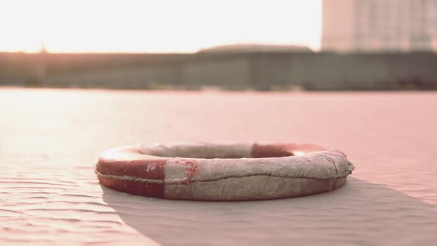 Lifebuoy on the city beach at sunset photo